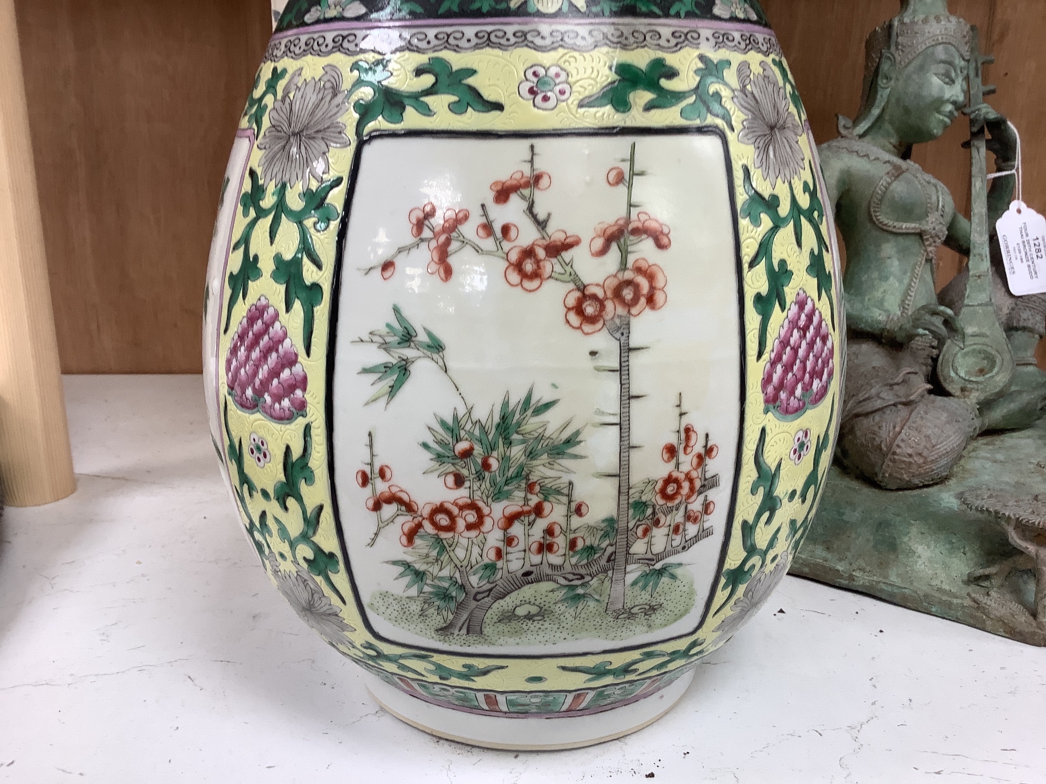 A large 19th century Chinese famille verte yellow ground bottle vase, height 47cm, restorations